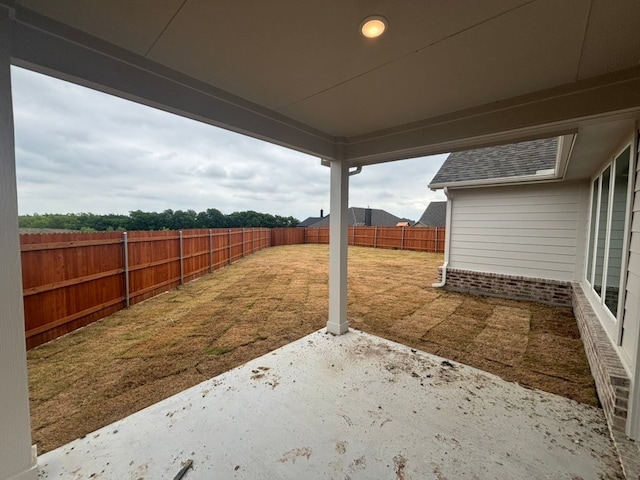 view of yard with a fenced backyard and a patio area