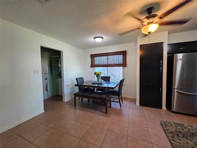 dining room with a textured ceiling, ceiling fan, and light tile patterned flooring