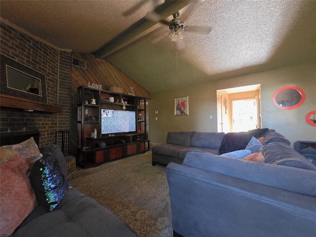 carpeted living room with a textured ceiling, visible vents, ceiling fan, and vaulted ceiling with beams