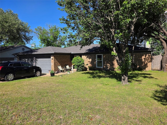 ranch-style house with an attached garage, a front lawn, and brick siding