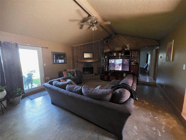 living room with a ceiling fan, a textured ceiling, finished concrete flooring, a brick fireplace, and vaulted ceiling with beams