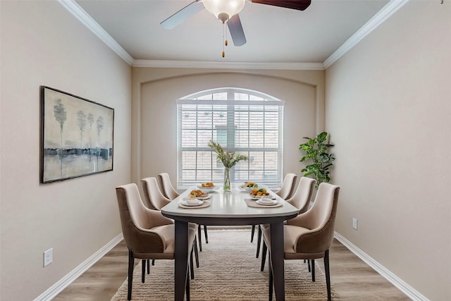 dining space featuring light wood-style floors, ceiling fan, and baseboards