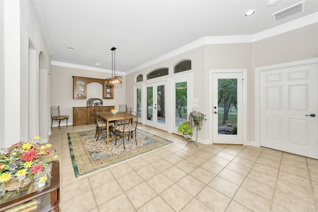 dining area featuring ornamental molding, french doors, baseboards, visible vents, and light tile patterned flooring