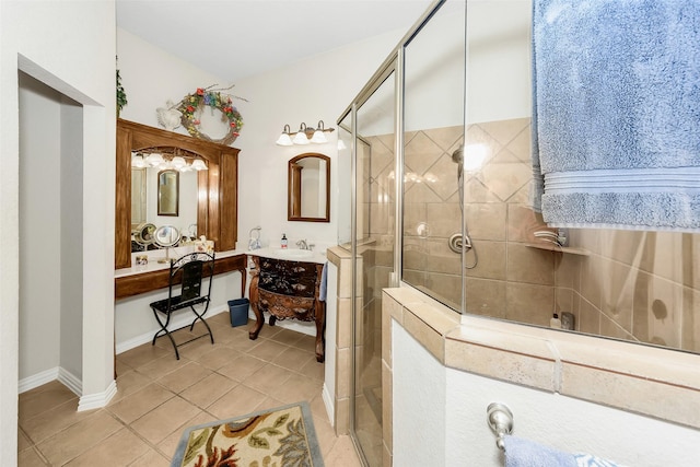full bath with tile patterned floors, vanity, a stall shower, and baseboards
