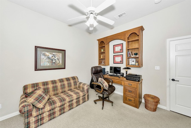 carpeted office featuring a ceiling fan, visible vents, and baseboards