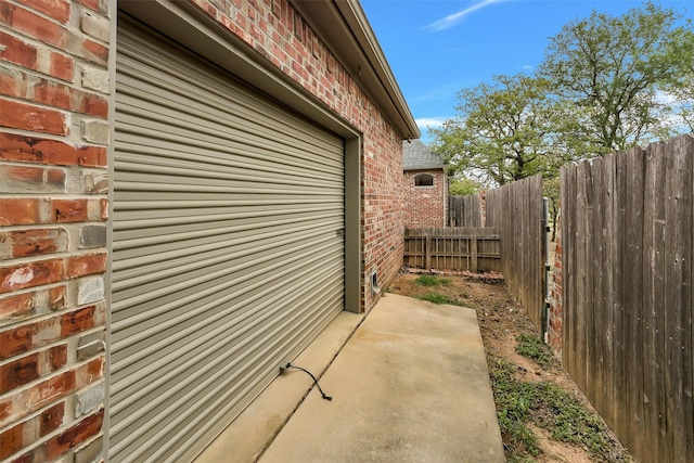 view of home's exterior featuring fence and brick siding