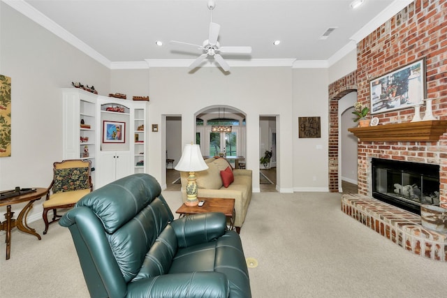 living room with arched walkways, carpet flooring, a ceiling fan, and a fireplace