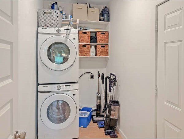 100 Winchester Cir, Gun Barrel City, TX 75156 - clothes washing area featuring baseboards, stacked washing maching and dryer, and laundry area