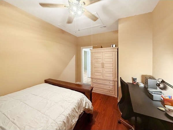 100 Winchester Cir, Gun Barrel City, TX 75156 - bedroom featuring dark wood-style flooring, a ceiling fan, and attic access