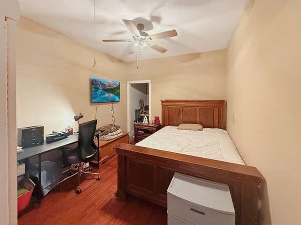 100 Winchester Cir, Gun Barrel City, TX 75156 - bedroom featuring a ceiling fan and dark wood-style flooring