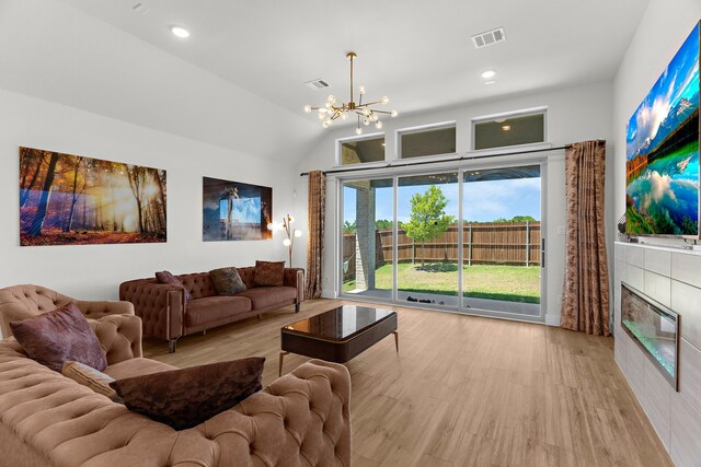 3432 Loftwood Ln, Anna, TX 75409 - living area featuring wood finished floors, a chandelier, a fireplace, vaulted ceiling, and recessed lighting