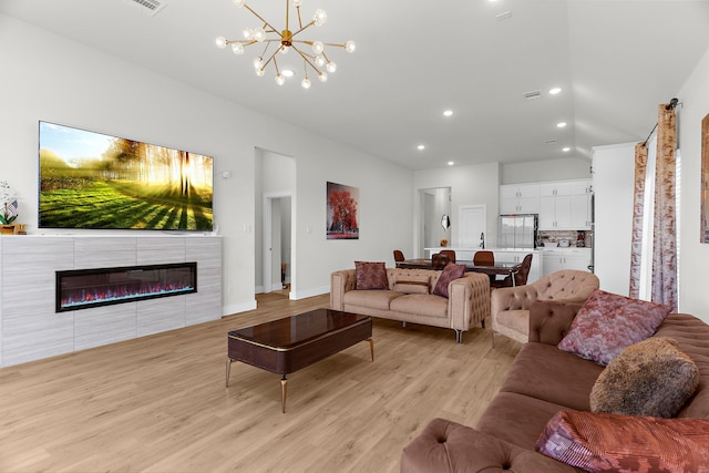3432 Loftwood Ln, Anna, TX 75409 - living room featuring light wood-type flooring, a chandelier, recessed lighting, baseboards, and vaulted ceiling
