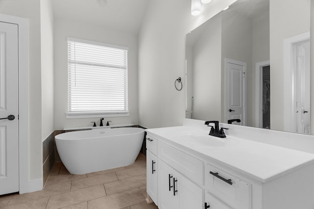 3432 Loftwood Ln, Anna, TX 75409 - bathroom featuring vanity, a freestanding tub, tile patterned floors, and lofted ceiling