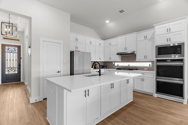 3432 Loftwood Ln, Anna, TX 75409 - kitchen with appliances with stainless steel finishes, a sink, vaulted ceiling, white cabinetry, and recessed lighting