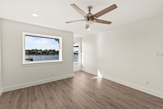 unfurnished room featuring recessed lighting, baseboards, ceiling fan, and wood finished floors