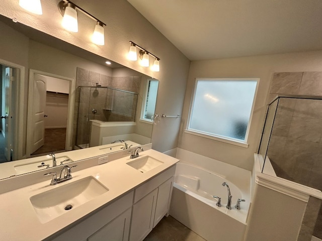 full bathroom with a sink, a shower stall, and a garden tub