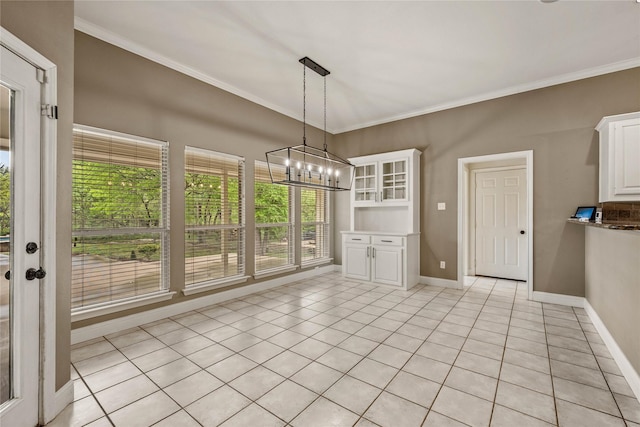 unfurnished dining area featuring ornamental molding, baseboards, a chandelier, and light tile patterned floors