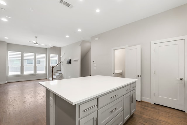 4914 Live Oak St Unit 7, Dallas, TX 75206 - kitchen with dark wood-type flooring, a kitchen island, a ceiling fan, light countertops, and gray cabinets