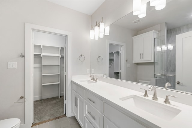 4914 Live Oak St Unit 7, Dallas, TX 75206 - bathroom with toilet, a shower with shower door, tile patterned flooring, and a walk in closet