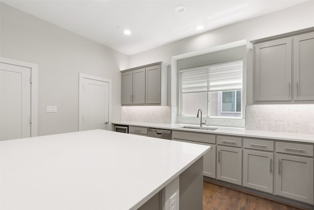 4914 Live Oak St Unit 7, Dallas, TX 75206 - kitchen with gray cabinets, a sink, stainless steel dishwasher, tasteful backsplash, and recessed lighting