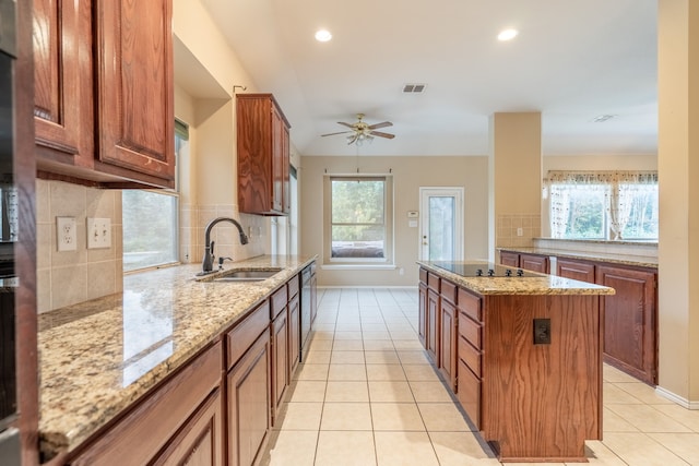 2515 Cambridge Dr, Heath, TX 75032 - kitchen featuring a sink, black electric cooktop, backsplash, light tile patterned floors, and baseboards