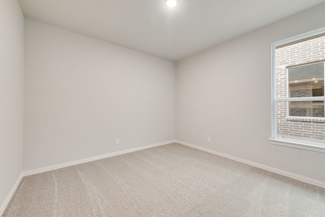 3523 Columbus St, Gainesville, TX 76240 - empty room with light colored carpet, baseboards, and plenty of natural light