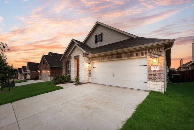 3523 Columbus St, Gainesville, TX 76240 - view of front of home with stone siding, concrete driveway, roof with shingles, central AC, and a garage
