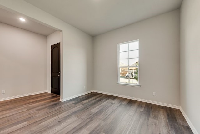 3523 Columbus St, Gainesville, TX 76240 - unfurnished room featuring dark wood finished floors, baseboards, and recessed lighting