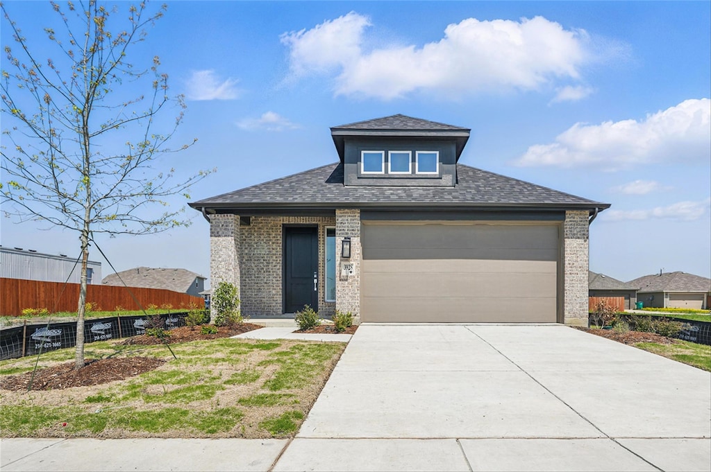 3928 Bison Ln, Heartland, TX 75126 - prairie-style home with brick siding, driveway, an attached garage, and a shingled roof