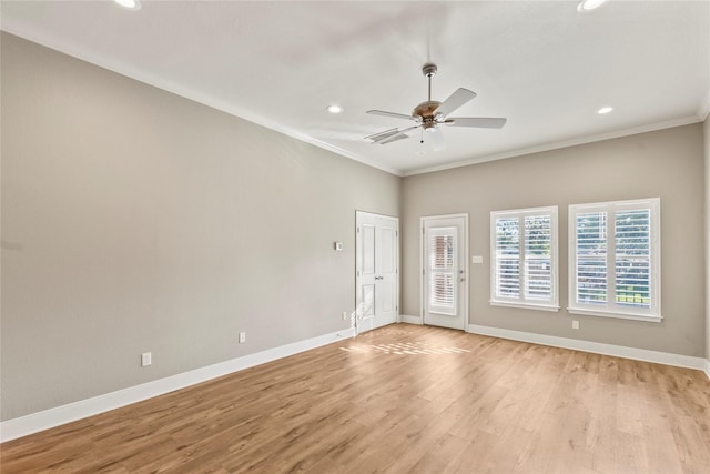 unfurnished room with baseboards, ornamental molding, light wood-type flooring, and a ceiling fan