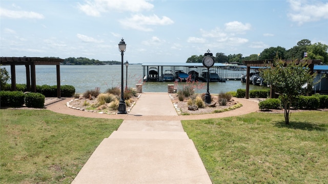 dock area featuring a lawn and a water view