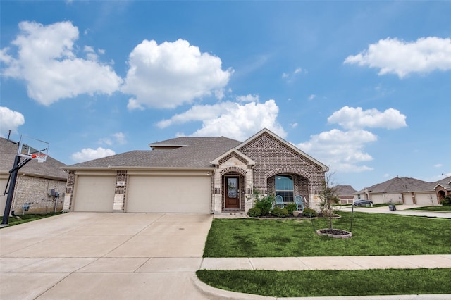 799 Bayberry Ln, Princeton, TX 75407 - view of front of house featuring a front lawn, roof with shingles, brick siding, an attached garage, and driveway