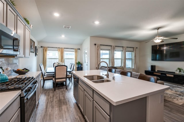 799 Bayberry Ln, Princeton, TX 75407 - kitchen with visible vents, open floor plan, a sink, appliances with stainless steel finishes, and gray cabinetry