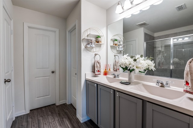 799 Bayberry Ln, Princeton, TX 75407 - full bath with wood finished floors, visible vents, a sink, and a stall shower