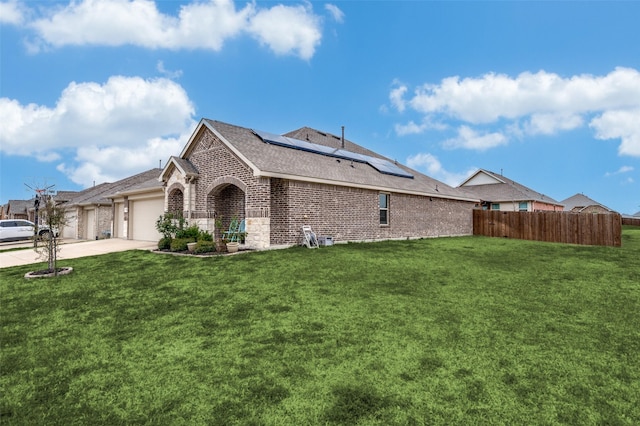 799 Bayberry Ln, Princeton, TX 75407 - view of side of property featuring brick siding, a garage, a lawn, and roof mounted solar panels