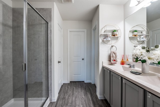 799 Bayberry Ln, Princeton, TX 75407 - full bath with vanity, baseboards, a shower stall, and wood finished floors