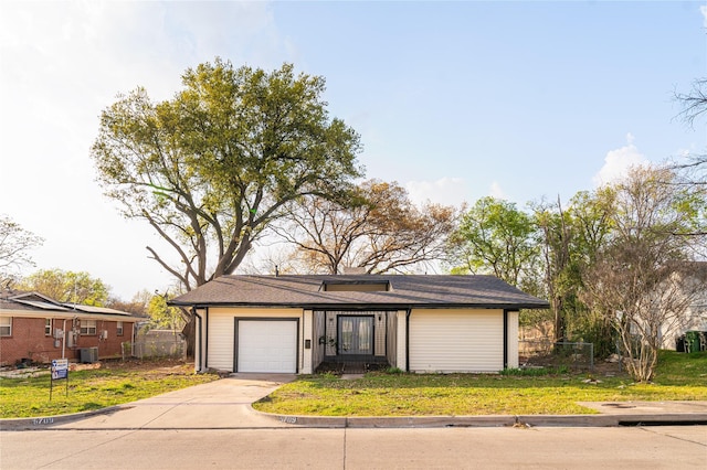 view of front of house featuring driveway, central AC, a front yard, and fence