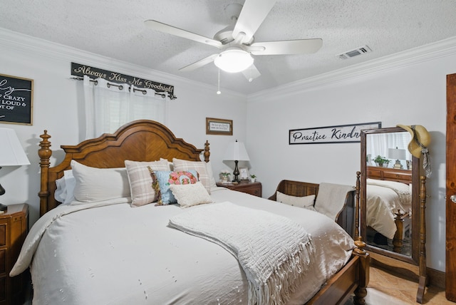 bedroom with crown molding, a textured ceiling, visible vents, and ceiling fan