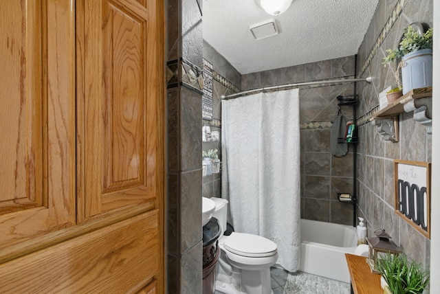full bath with toilet, tile patterned floors, shower / bath combo, and a textured ceiling