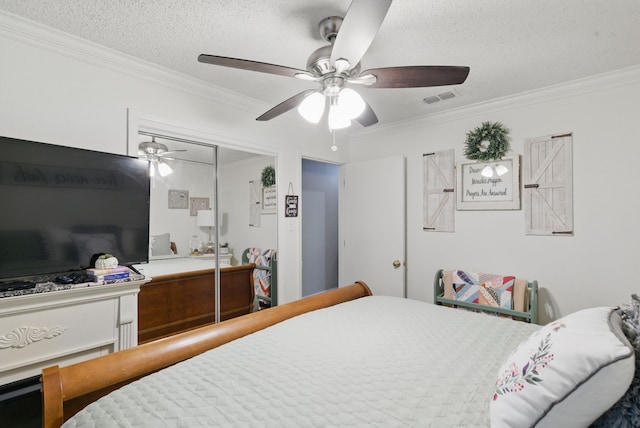 bedroom featuring a ceiling fan, visible vents, crown molding, and a textured ceiling