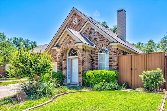 775 Marble Canyon Cir, Irving, TX 75063 - view of front facade with a gate, a front lawn, a chimney, and brick siding
