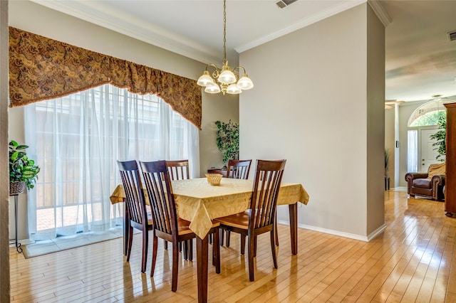775 Marble Canyon Cir, Irving, TX 75063 - dining area with light wood-style flooring, baseboards, ornamental molding, an inviting chandelier, and visible vents