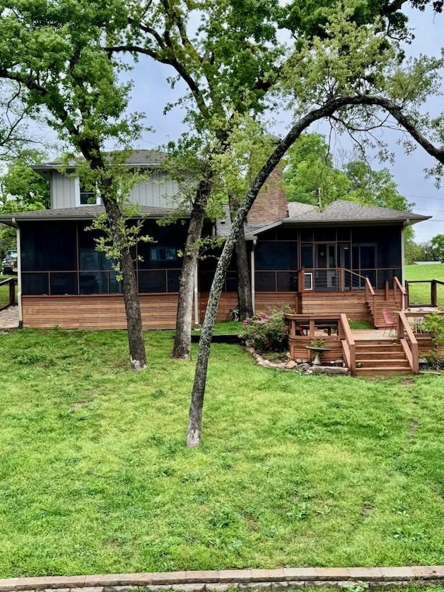 316 Oak Ln, Tool, TX 75143 - rear view of house with a sunroom, a lawn, and stairway