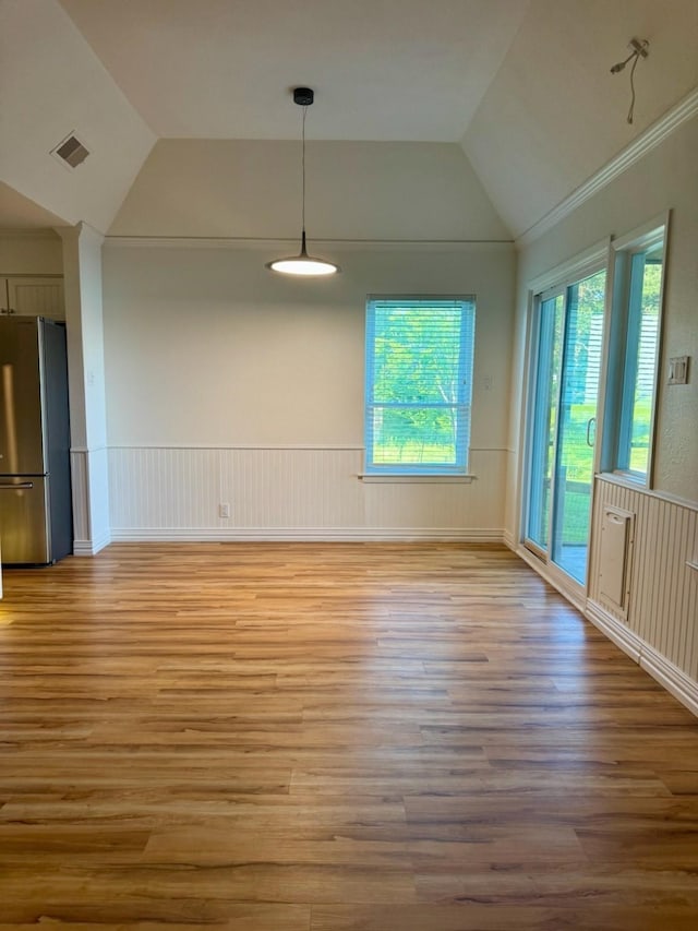 316 Oak Ln, Tool, TX 75143 - unfurnished room featuring lofted ceiling, light wood-type flooring, and wainscoting