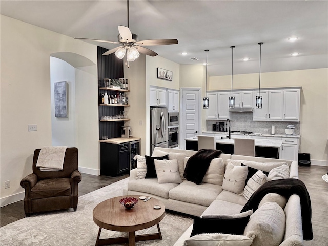 2312 Camp St, Aubrey, TX 76227 - living area with a dry bar, wood finished floors, ceiling fan, wine cooler, and recessed lighting