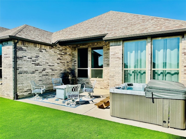 2312 Camp St, Aubrey, TX 76227 - rear view of property featuring a hot tub, a patio, brick siding, and roof with shingles
