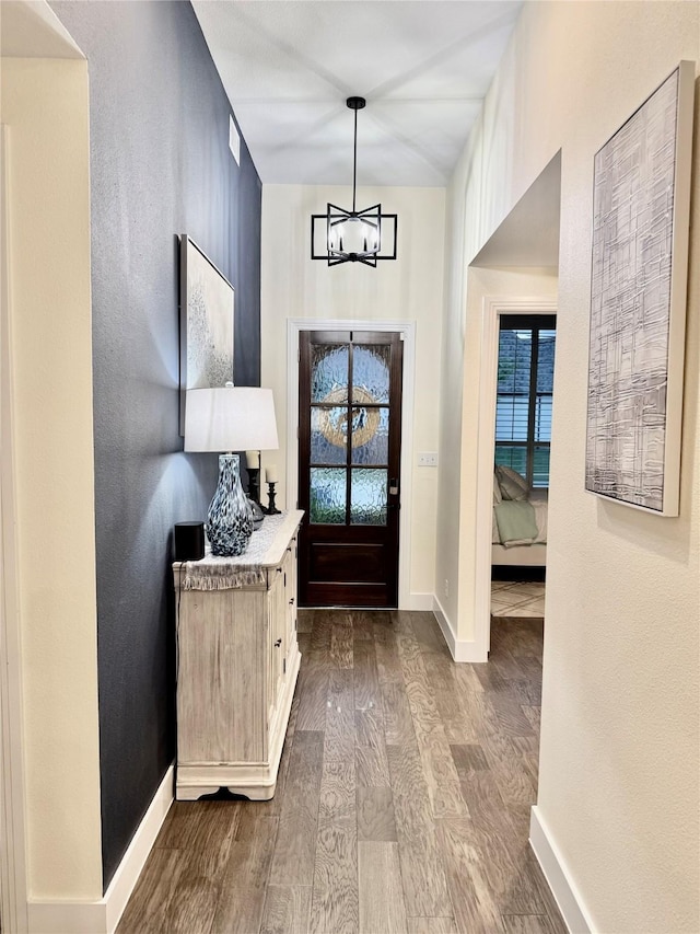 2312 Camp St, Aubrey, TX 76227 - foyer entrance featuring dark wood-style floors, a chandelier, and baseboards