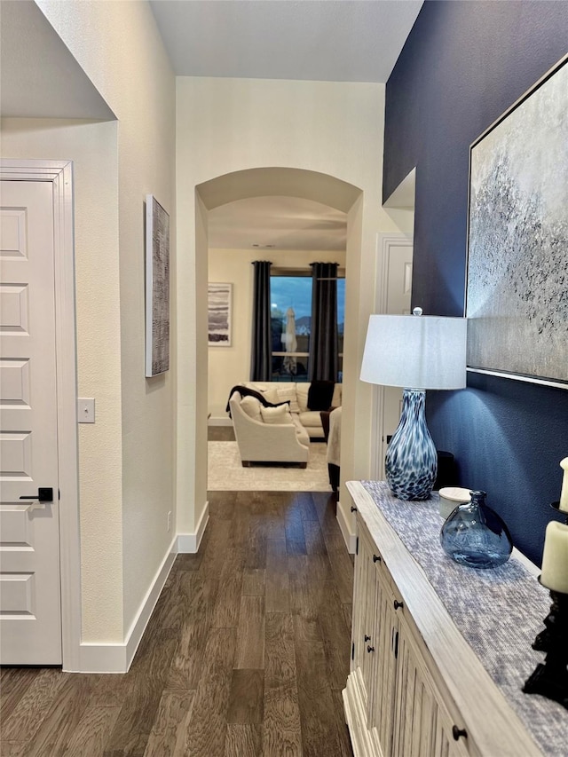 2312 Camp St, Aubrey, TX 76227 - hall with arched walkways, dark wood-style flooring, and baseboards