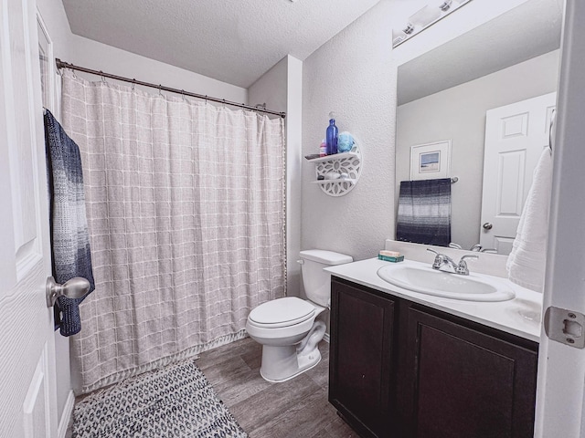 82 Brushy Creek Ln, Terrell, TX 75160 - full bathroom featuring wood finished floors, a textured ceiling, toilet, vanity, and curtained shower