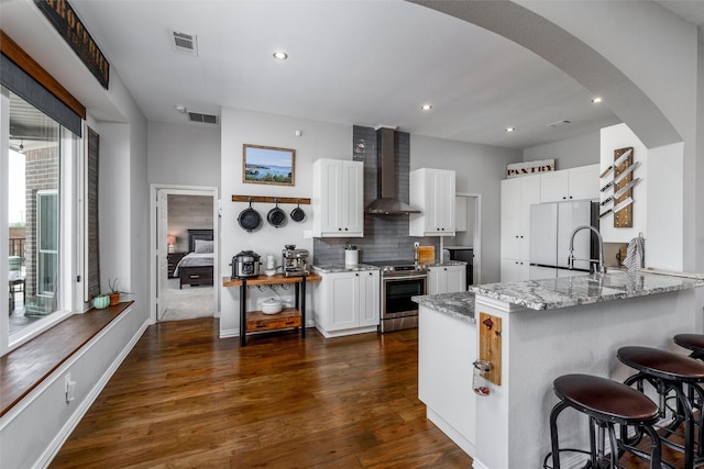 800 Overland Dr, Lowry Crossing, TX 75069 - kitchen with wall chimney exhaust hood, stainless steel electric range, freestanding refrigerator, light stone counters, and recessed lighting